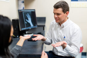 Ken Unruh MD hand surgeon with patient